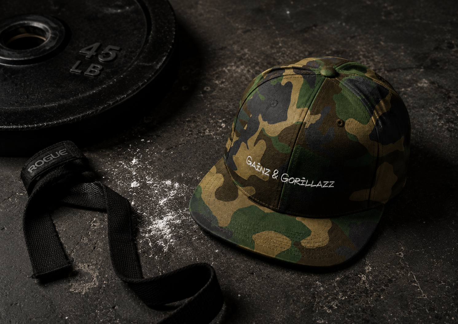 Gainz & Gorillazz camo snapback hat with weightlifting gear in a gym