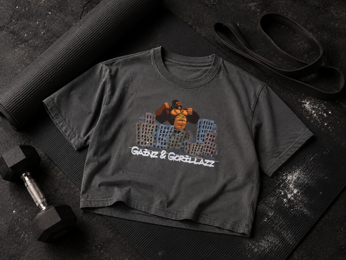 Gainz & Gorillazz OG Gorilla cropped tee styled with a yoga mat, resistance band, and dumbbell